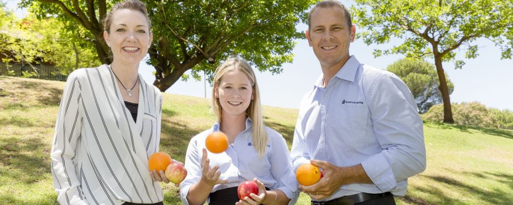 Minister Mia Davies, Scholarship winner Jessica Cruickshank and RLSSWA CEO Peter Leaversuch holding fruit