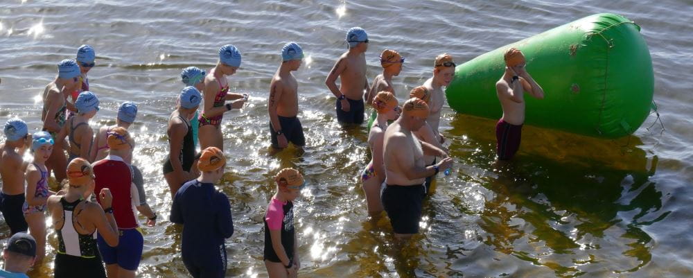 Swimmers at the start line in the river