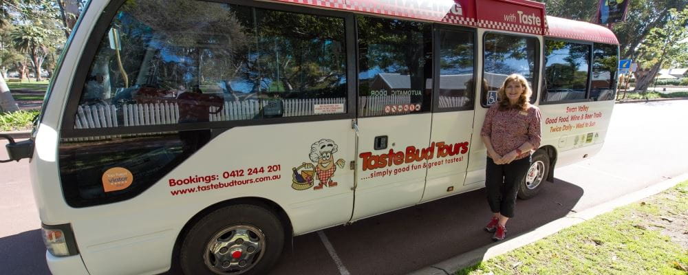 image of Taste Bud Tours bus with Loris Harding standing beside