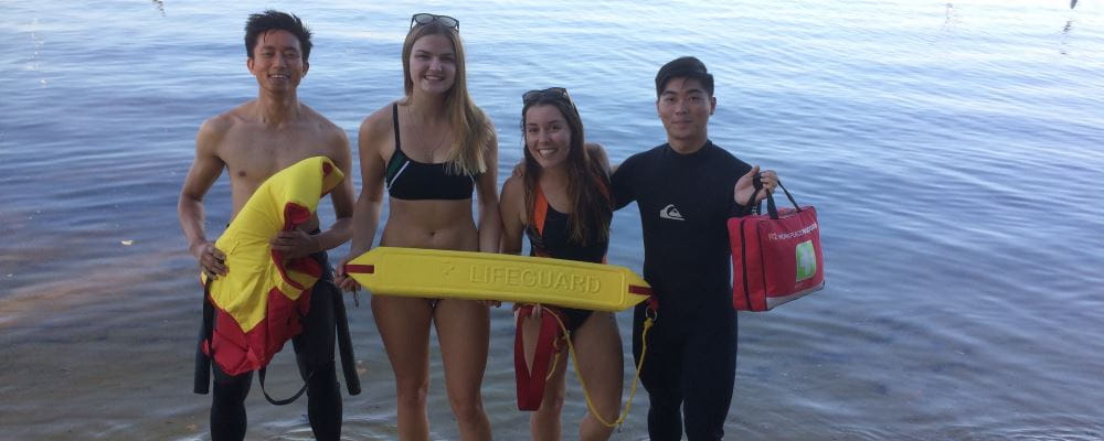 Four young people by the Swan River with lifesaving gear