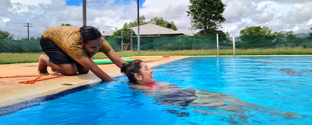 two teachers practising aquatic rescues at Warmun Pool