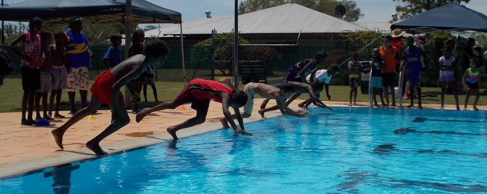 aboriginal children diving into the pool at Warmun
