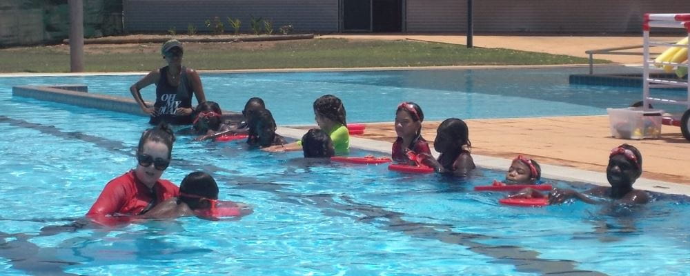 Swimming Instructor Kiah Stanbishop with aboriginal children int he pool at Warmun
