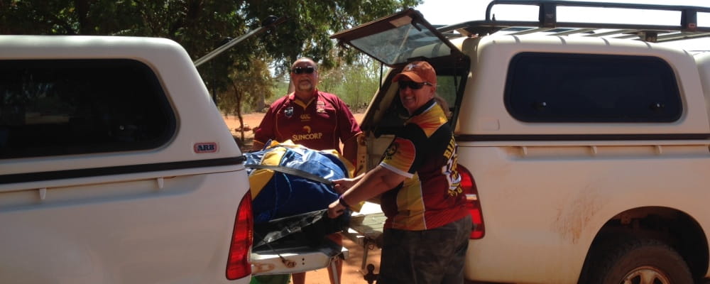 remote pool managers Trevor Caporn and Bernie Egan transfering the Watch Around Water inflatable between their cars in remote WA