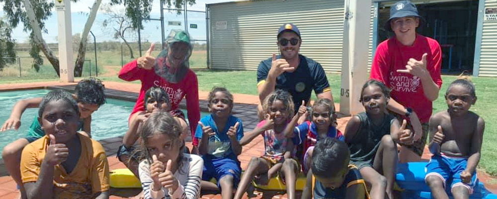 Jigalong children with their swim instructors by the pool