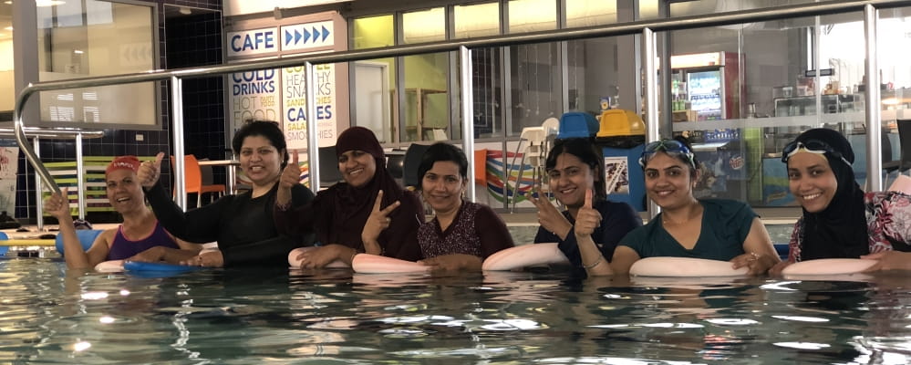 A group of multicultural women partake in the swim and survive swimming lessons