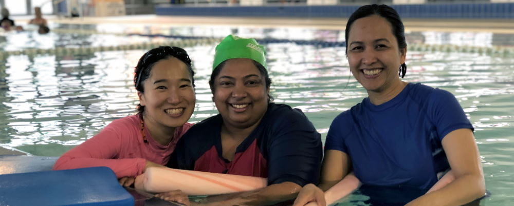 Three multicultural women in a swimming pool