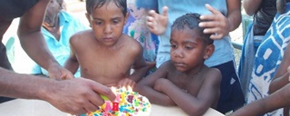 image of birthday boy Elijah with his birthday cake