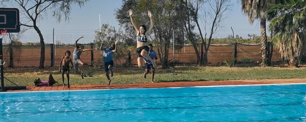 group of kids jumping into yandeyarra remote swimming pool