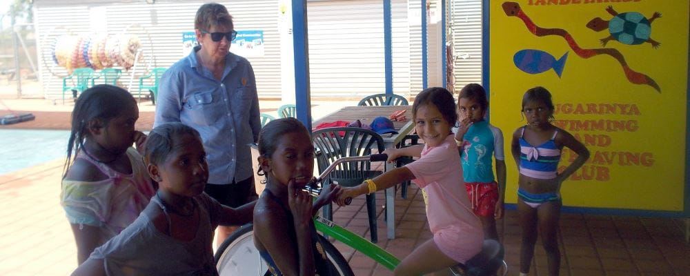 Aboriginal children with Jenny from EON enjoying the smoothie bike