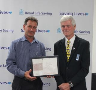 Camern Eglington receiving his award from RLSSWA President Colin Hassell