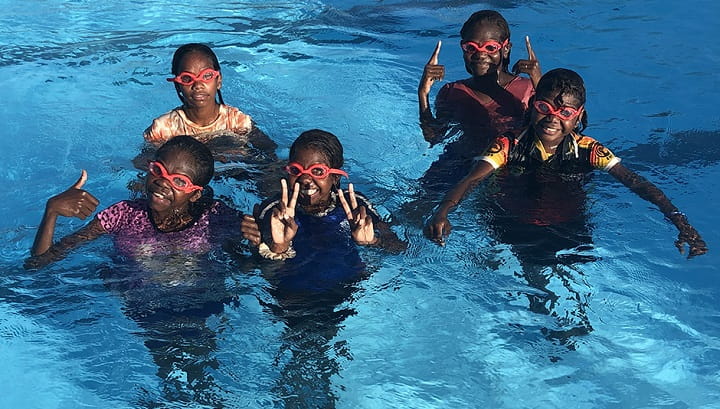 five Aboriginal girls wearing goggles in a swimming pool