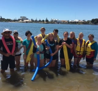 A group of young people in the Leschenault Inlet with a rescue boat