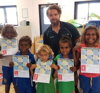 Five aboriginal children with thier swimming certificates and Burringurrah pool manager Aaron 
