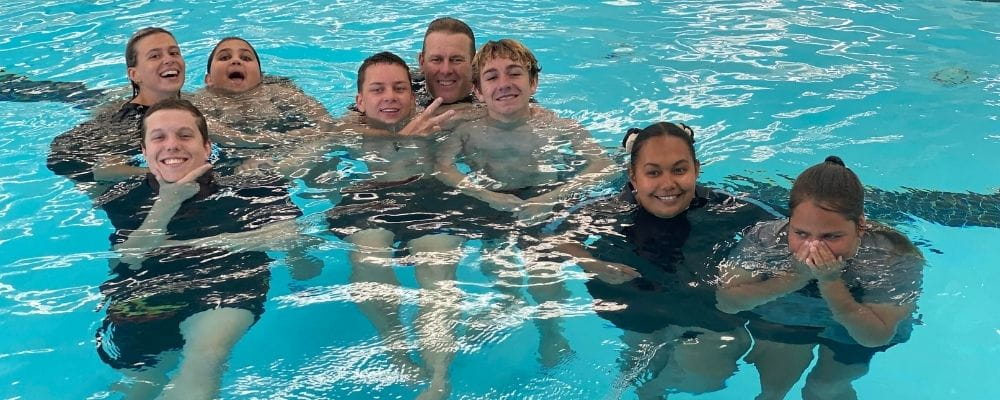 Clarkson students in the pool with Chaplian Scott Currie