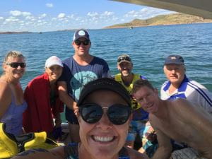Lake Argyle swim team members and volunteers in a boat on Lake Argyle