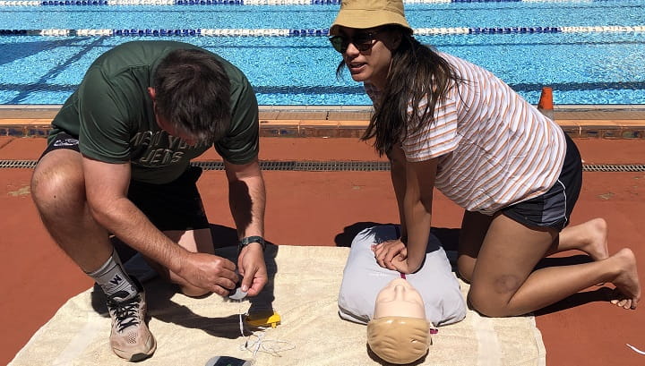 Newman SHS staff practising CPR on a manikin