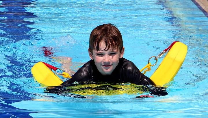 Child floating on rescue tube in the water