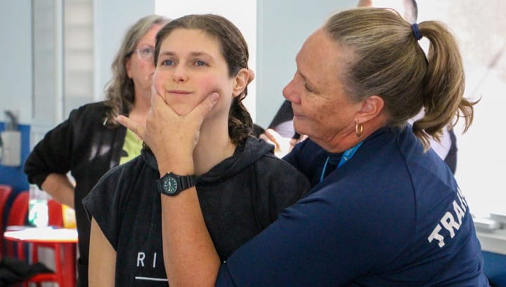 trainer demonstrating a chin grip