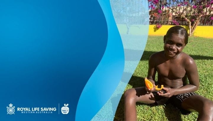Aboriginal boy eating fruit at the Warburton Pool