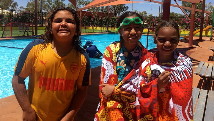 three smiling aboriginal kids after a swimming lesson