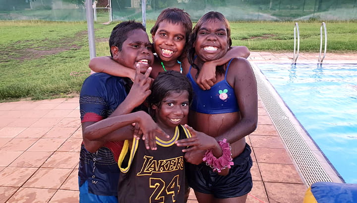 Four Aboriginal boys by the pool at Warmun