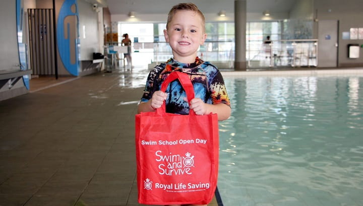 boy holding Swim and Survive bag