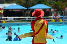 Lifeguard standing by a pool