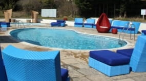 A swimming pool with chairs
