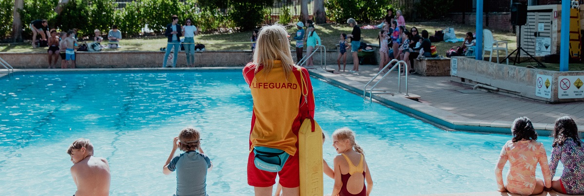 lifeguard supervising a school pool