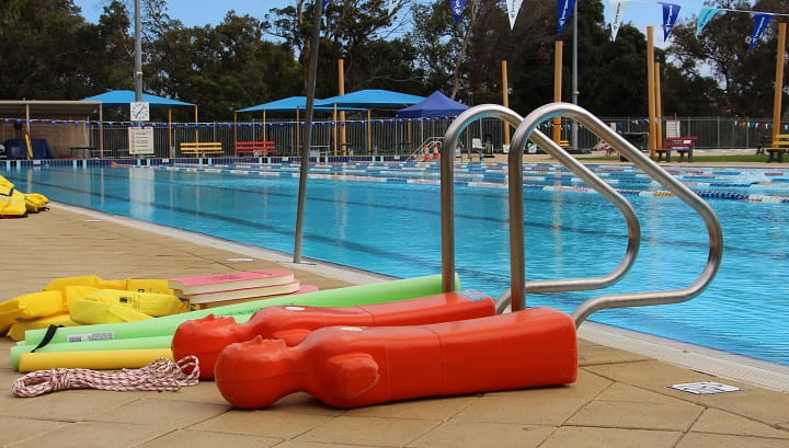 pool rescue equipment lying by side of pool