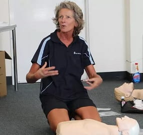 first aid trainer speaking to class