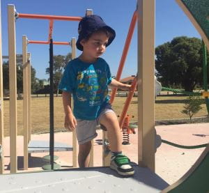 Lachlan playing at a playground