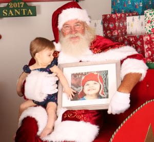 Baby Rosalie with Santa and a photo of big brother Lachlan