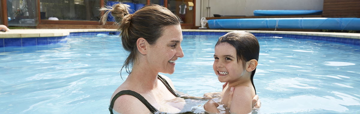 A mum in the pool with her toddler boy