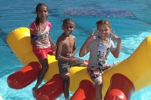 Burringurrah children on a giant pool inflatable