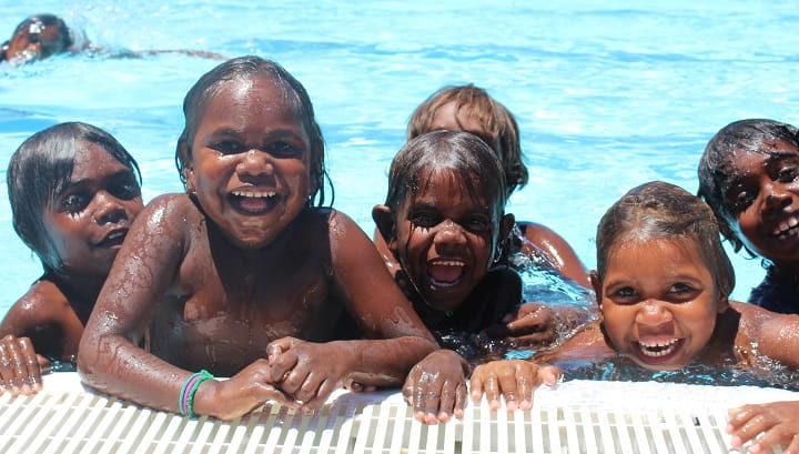 group of six young aboriginal boys in swimming pool
