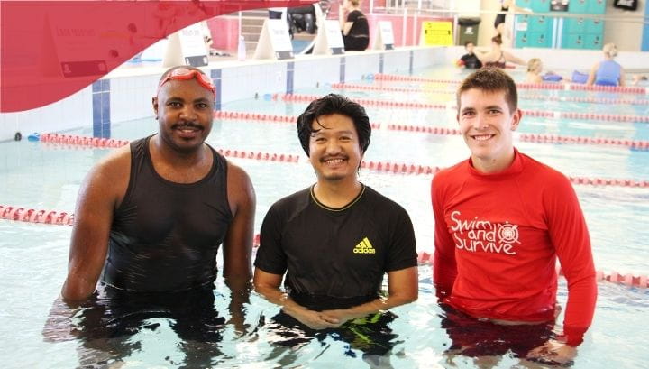 Two male participants and one male teacher in pool
