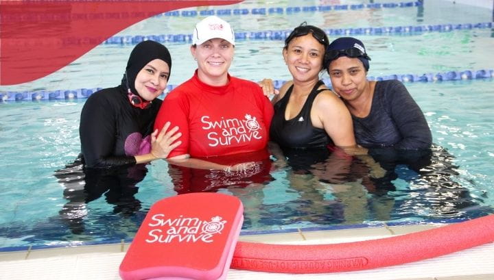 Three women participants with female teacher in pool