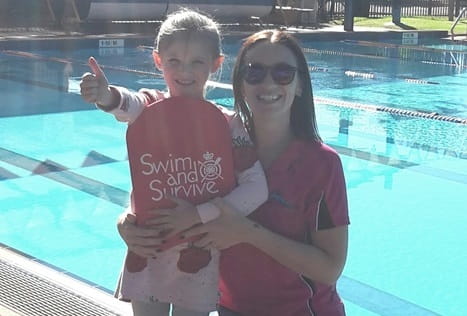 Izzy and her swim teacher Peta Brittain by the pool
