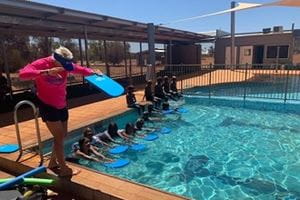 Trainer Dianne Crisp instructing her swimming students