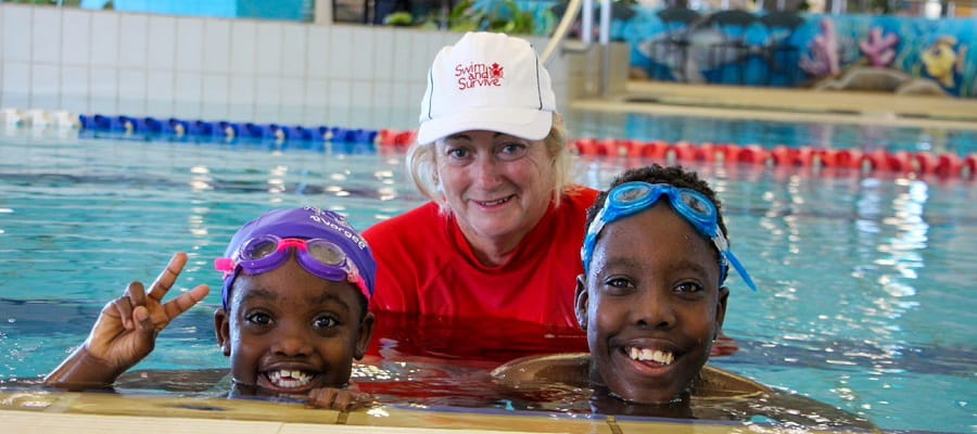 Swimming teacher Gayle Cruden with two multicultural students
