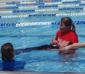Sallie Watson in the pool demonstrating lifesaving techniques