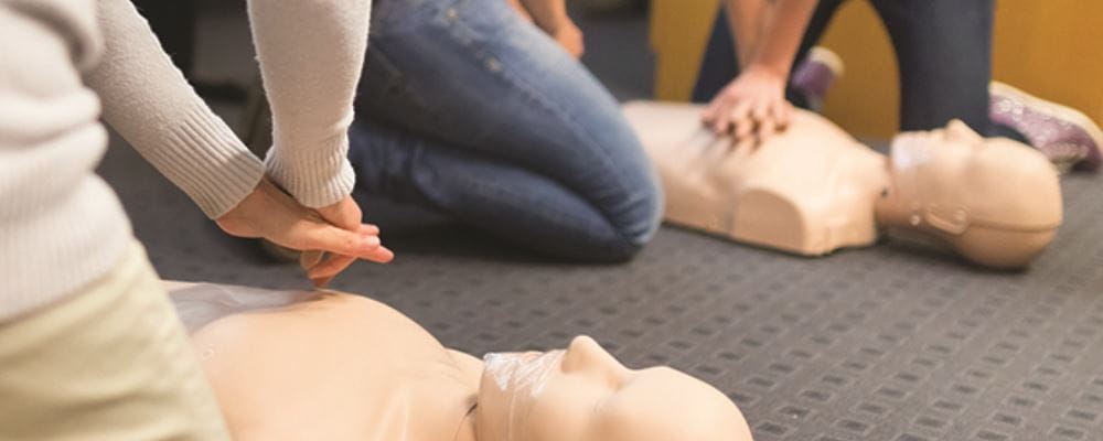 CPR Courses Perth and practicing CPR on a manikin