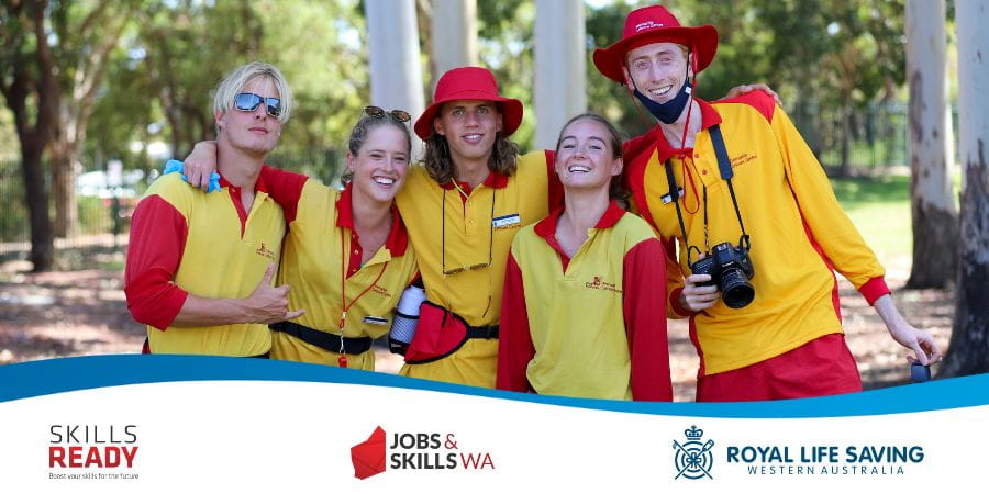 Five lifeguards in yellow and red uniforms smiling