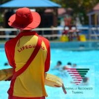 Pool lifeguard watching people swim from afar