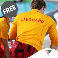 Lifeguard kneeling down to help person in pool