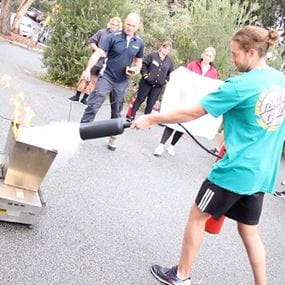 A student showing how to use a fire extinguisher