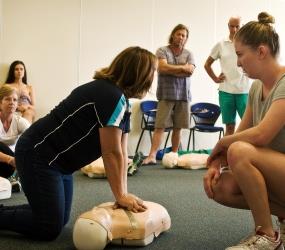 image of first aid trainer demonstrating to class