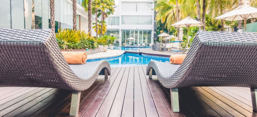 Two deck chairs by a pool at a hotel
